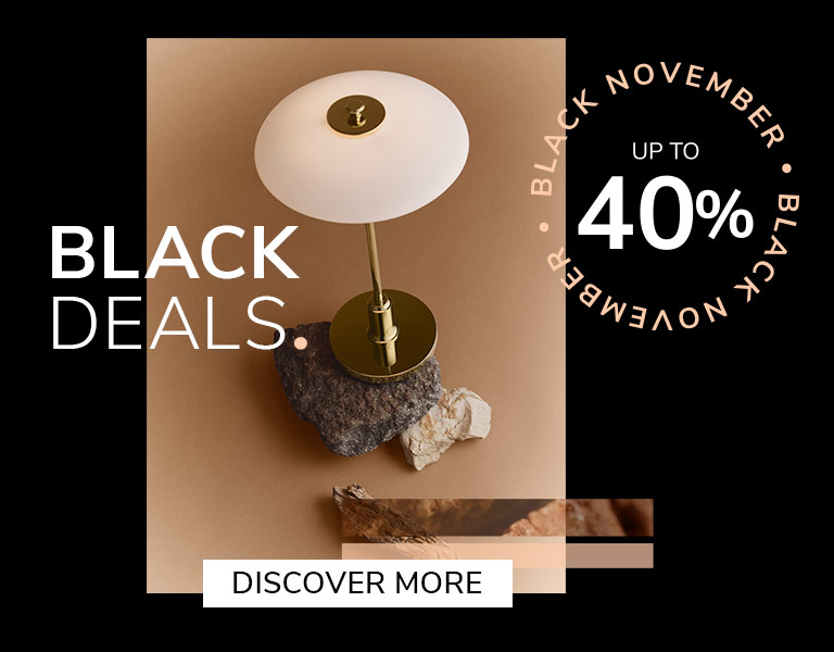 Discover More Elegant designer table lamp on natural stone base with gold stem and white shade, promoting Black November sale – up to 40% off with text ‘First Black Deals’ and ‘Discover More’ button.